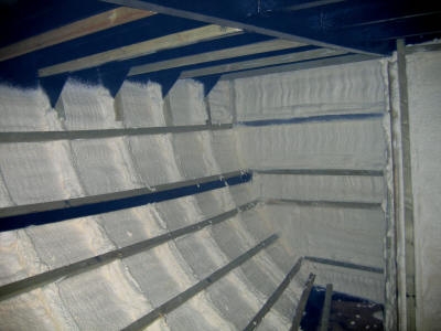 Foam insulation sprayed between the battens