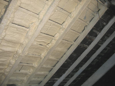 insulating between timber studs in a wooden frame 					construction